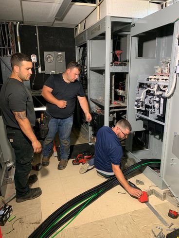 Electrician Checking A Fuse Box - licensed electrician in North Andover, MA