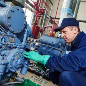 Repair — Worker at Industrial Compressor Station in Tulare, CA