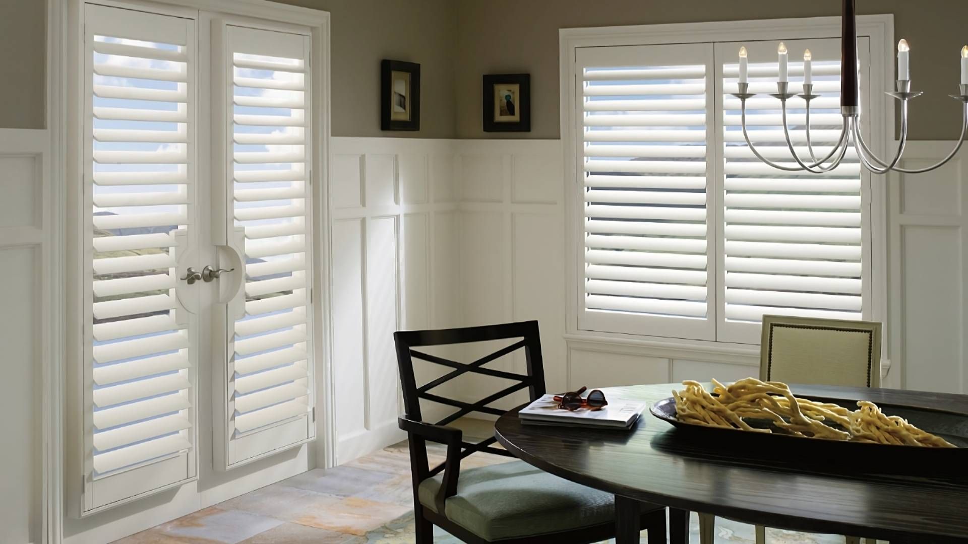 Hunter Douglas Palm Beach™ Polysatin™ Vinyl Shutters as French door window treatments in a dining ro