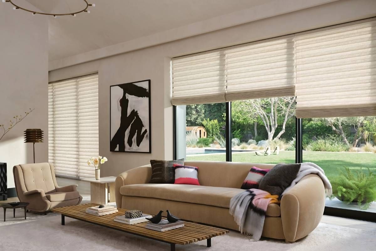Hunter Douglas Vignette® Roman Shades on large and wide windows in a cozy living room near Houston, TX
