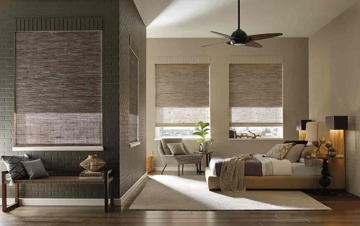 Hunter Douglas Provenance® Woven Wood Shades as bedroom window treatments in a modern and chic space at Window Magic Blinds & Drapery near Houston, TX