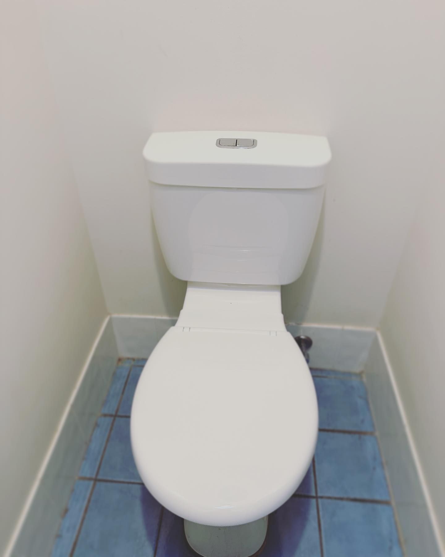 A White Toilet with A Dual-Flush Button — Port Macquarie Plumbing In Port Macquarie, NSW