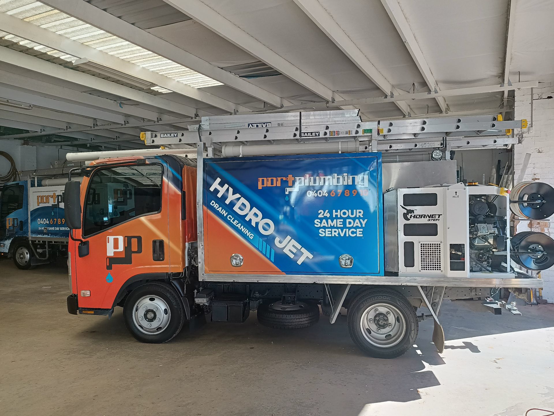 Hydro-jet Service Truck With Blue and Orange Logo — Port Macquarie Plumbing In Lake Cathie, NSW