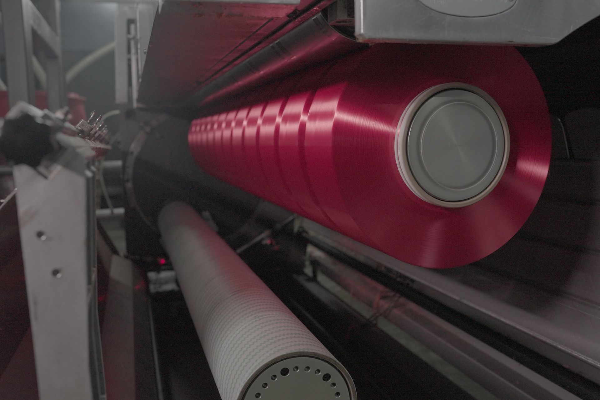 A close up of a machine with a red cylinder on it.