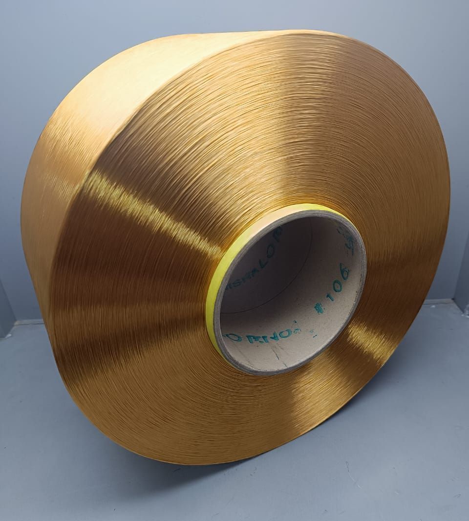 A bunch of spools of thread of different colors are stacked on top of each other.