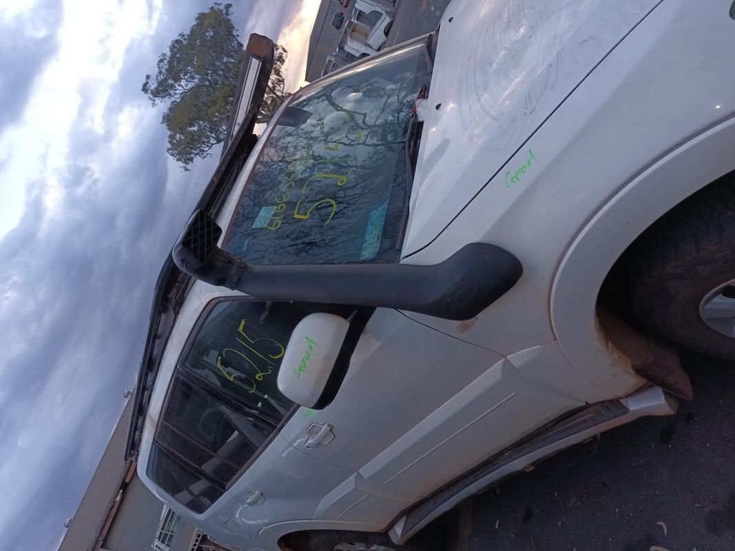 A White Car With a Broken Windshield is Parked on the Side of the Road — South West 4WD Wreckers In Brisbane, QLD