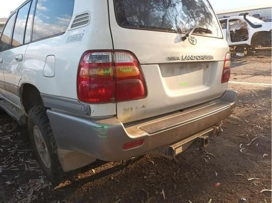 A White Land Cruiser is Parked in a Dirt Lot — South West 4WD Wreckers In Harristown, QLD