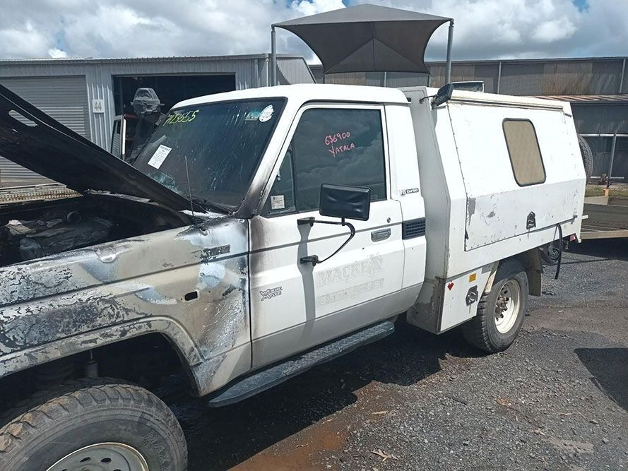 A White Truck with the Hood Up is Parked in a Parking Lot — South West 4WD Wreckers in Harristown, QLD 