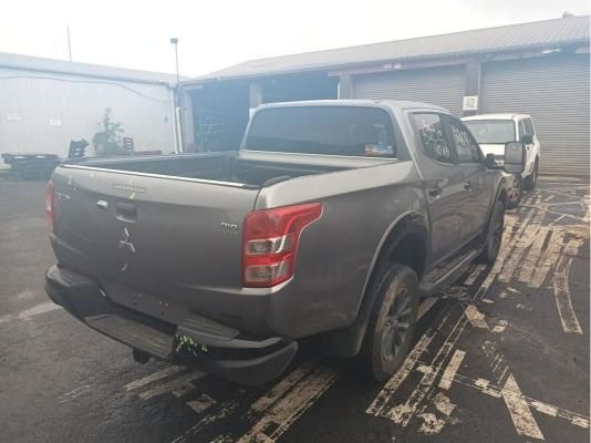 Gray Mitsubishi Pickup Truck Parked Near Buildings — South West 4WD Wreckers In Brisbane, QLD