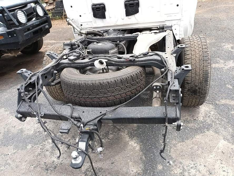 A White Truck with the Hood Up and a Spare Tire on the Back of It — South West 4WD Wreckers in Harristown, QLD 