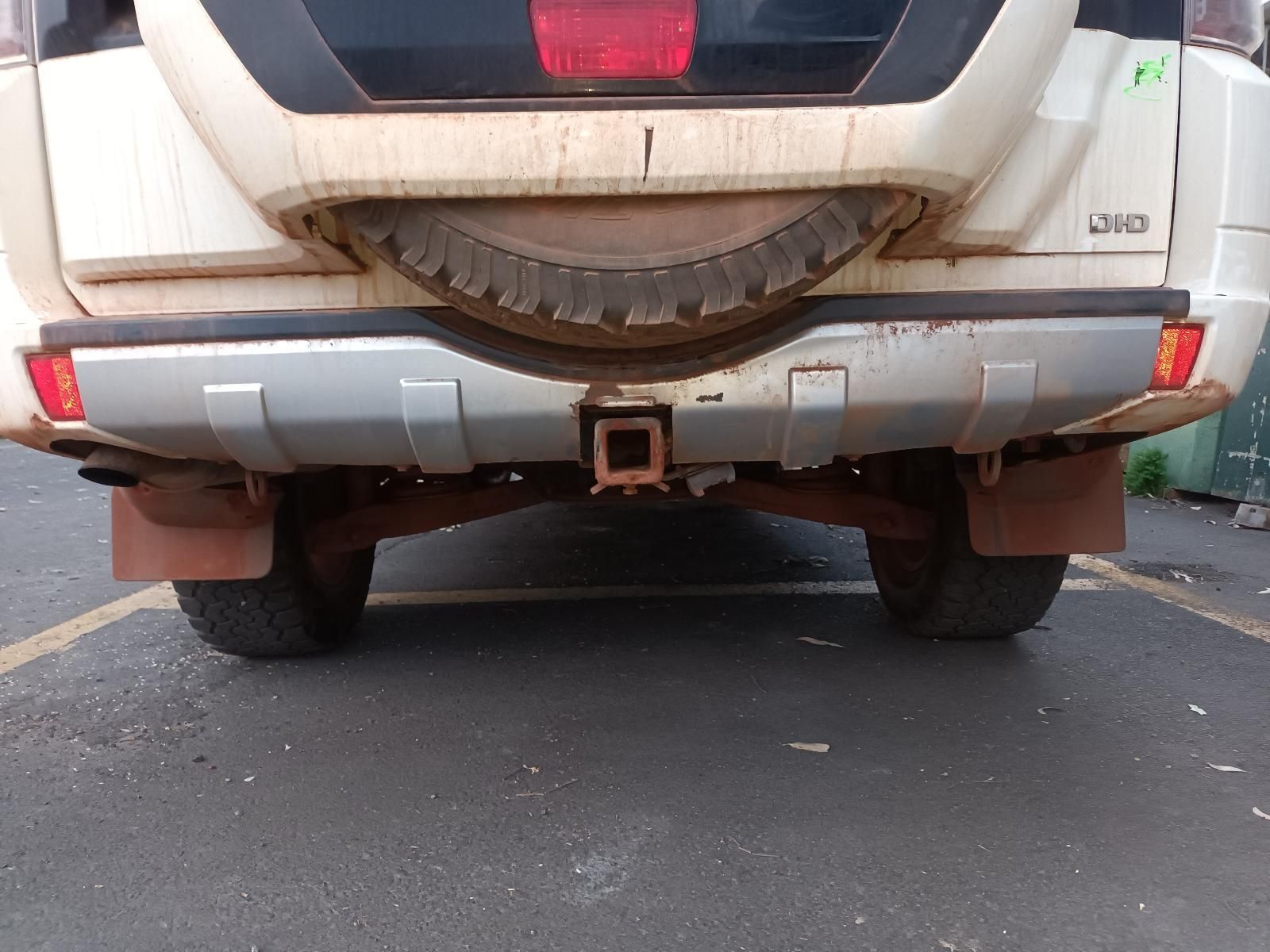 A White Suv With a Spare Tire is Parked in a Parking Lot — South West 4WD Wreckers In Brisbane, QLD