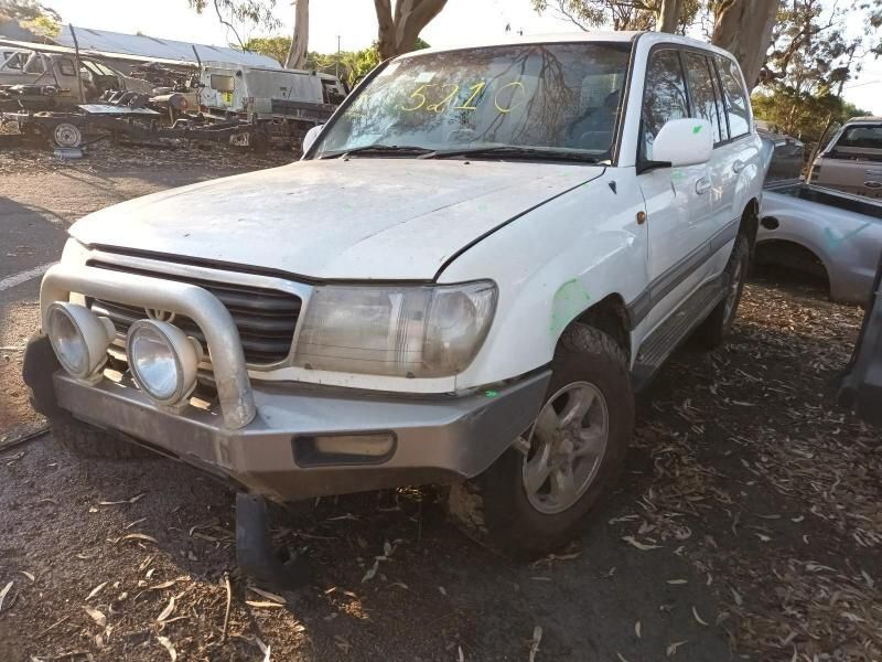 A White Toyota Land Cruiser is Parked in a Parking Lot — South West 4WD Wreckers In Harristown, QLD