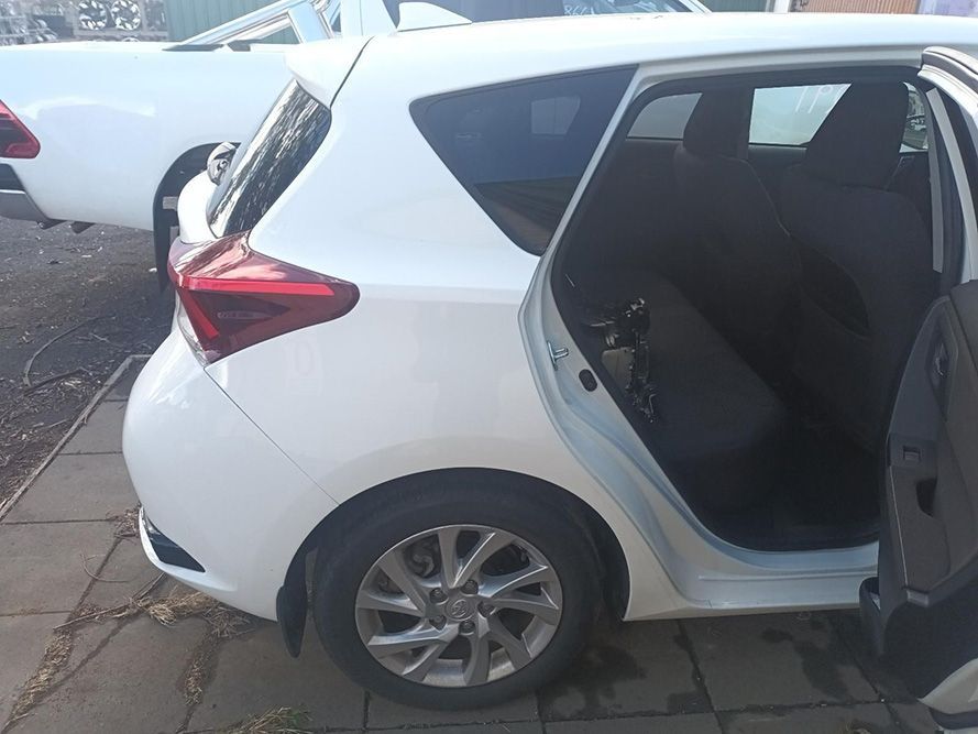 A White Car with the Door Open is Parked on a Sidewalk — South West 4WD Wreckers in Harristown, QLD