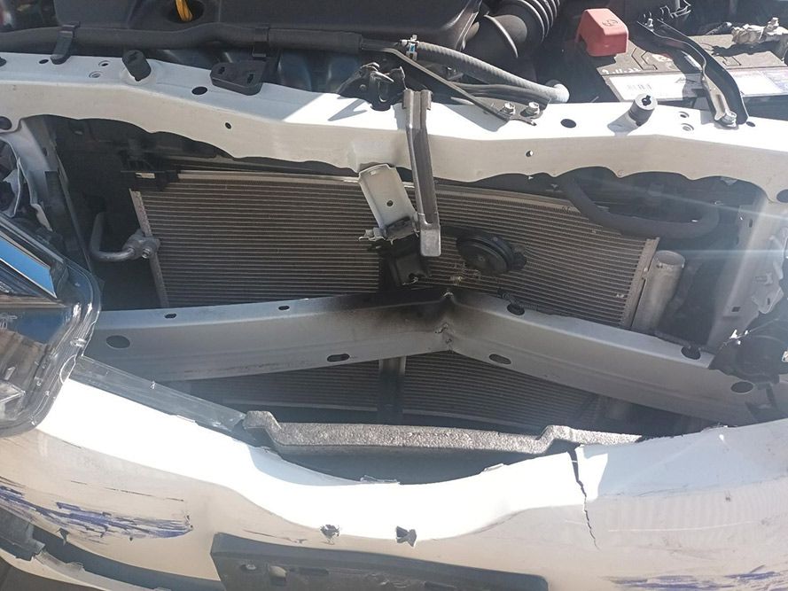 A White Car with the Hood Open and the Radiator Visible — South West 4WD Wreckers in Harristown, QLD