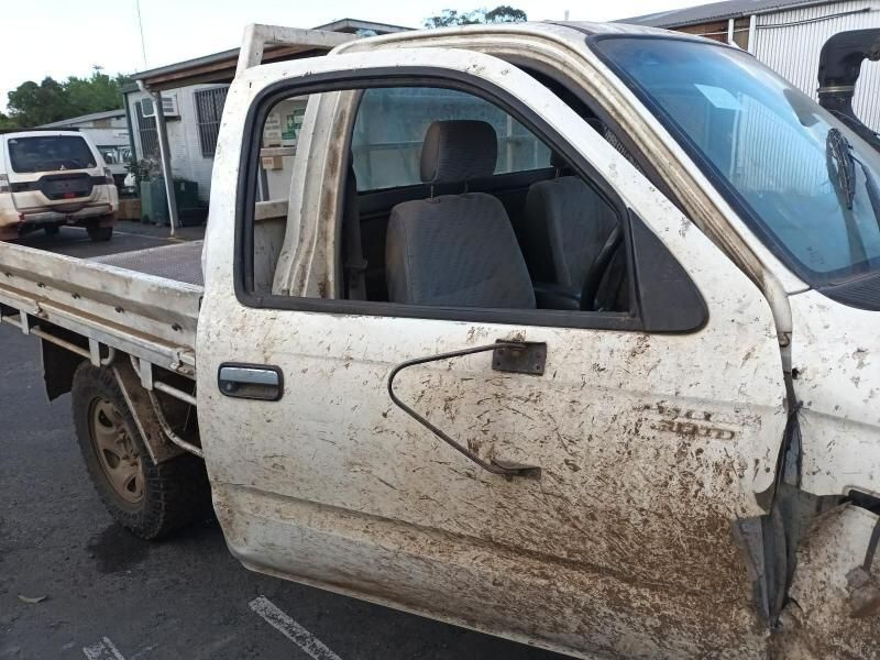A Dirty White Truck is Parked on the Side of the Road — South West 4WD Wreckers In Brisbane, QLD
