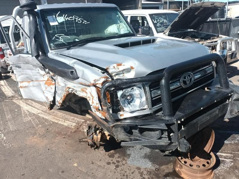 A Wrecked Toyota Land Cruiser is Sitting on the Side of the Road — South West 4WD Wreckers In Harristown, QLD
