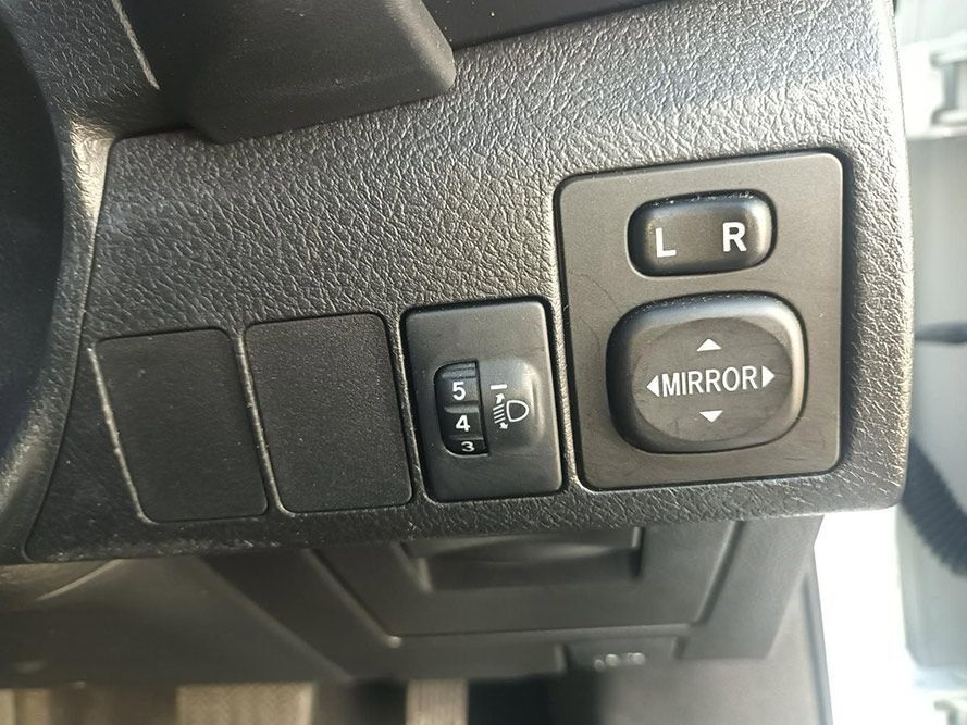 A Close Up of a Car Dashboard with a Mirror Switch — South West 4WD Wreckers in Harristown, QLD