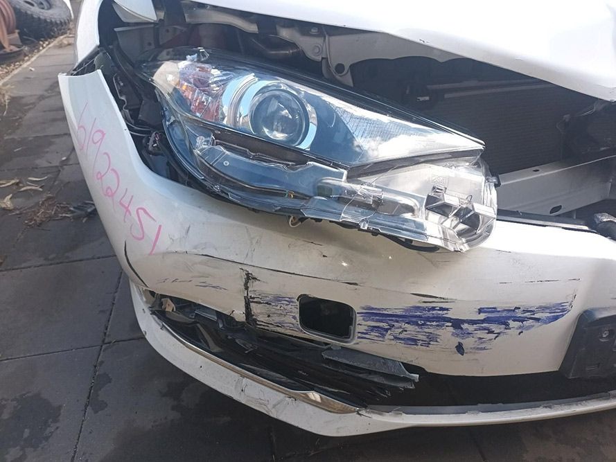 A White Car with a Damaged Front Bumper and Headlight — South West 4WD Wreckers in Harristown, QLD