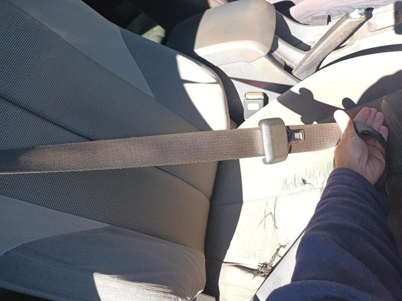 A Person is Holding a Seat Belt in a Car — South West 4WD Wreckers In Harristown, QLD