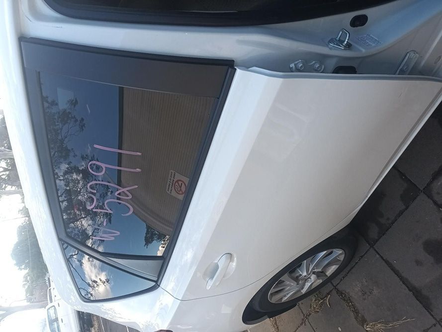 A White Car with the Door Open is Parked on a Sidewalk — South West 4WD Wreckers in Harristown, QLD