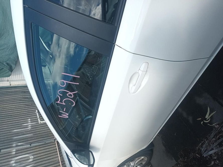 A White Car with a Numbers Written on the Door — South West 4WD Wreckers in Harristown, QLD