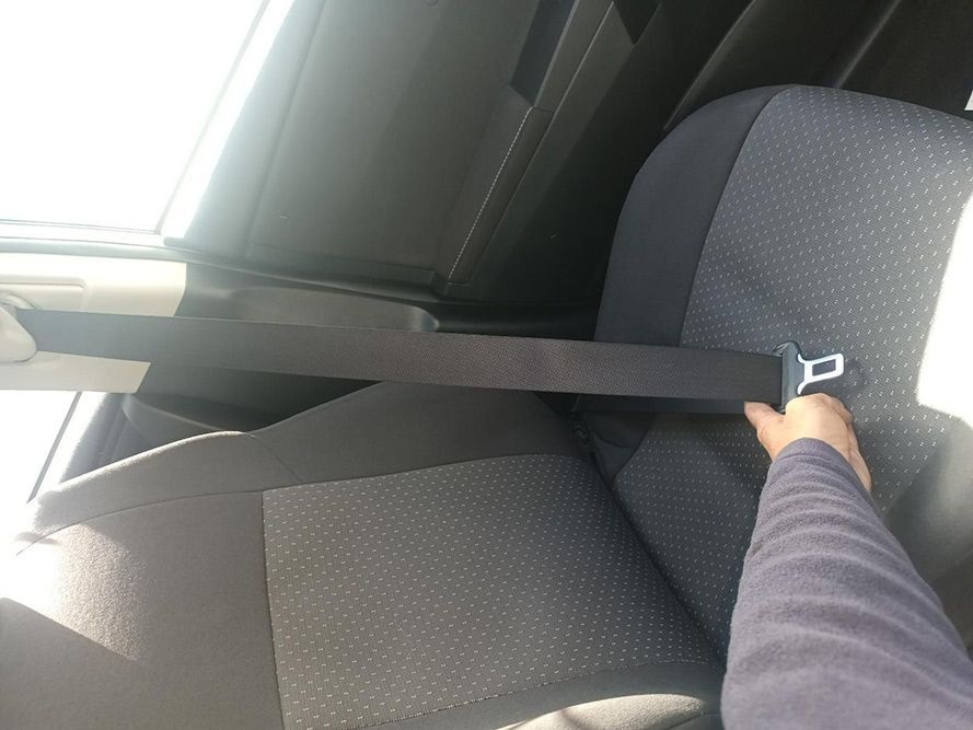 A Person is Putting on a Seat Belt in a Car — South West 4WD Wreckers in Harristown, QLD