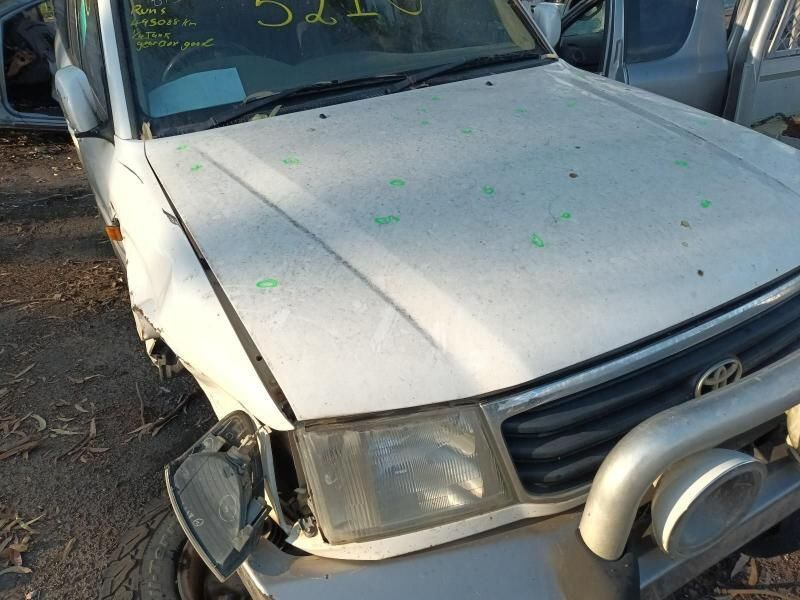 A White Car With a Broken Hood is Parked in a Lot — South West 4WD Wreckers In Harristown, QLD