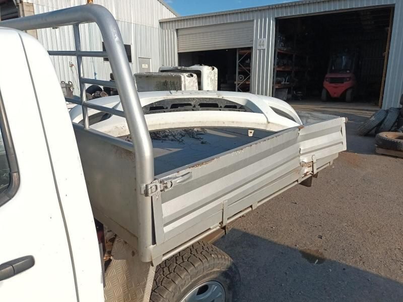 A White Truck is Parked in Front of a Garage With a Forklift in the Background — South West 4WD Wreckers In Harristown, QLD