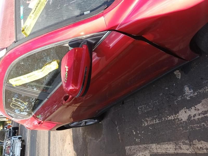 A Red Car is Parked on the Side of the Road — South West 4WD Wreckers In Brisbane, QLD