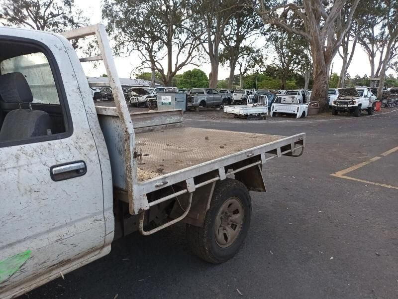 A White Truck With a Flat Bed is Parked in a Parking Lot — South West 4WD Wreckers In Brisbane, QLD