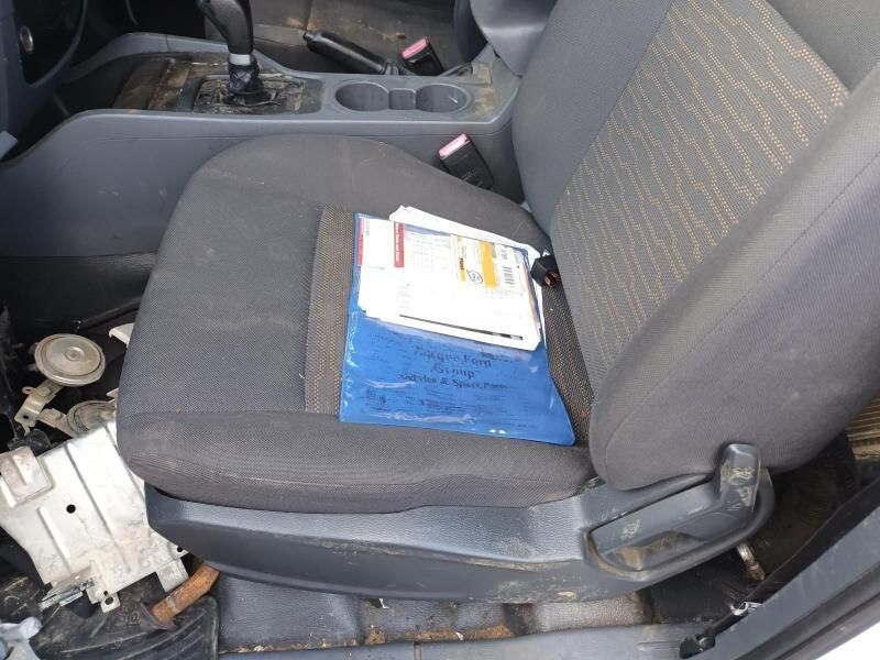 A Dirty Car Seat With a Blue Bag on It — South West 4WD Wreckers In Brisbane, QLD