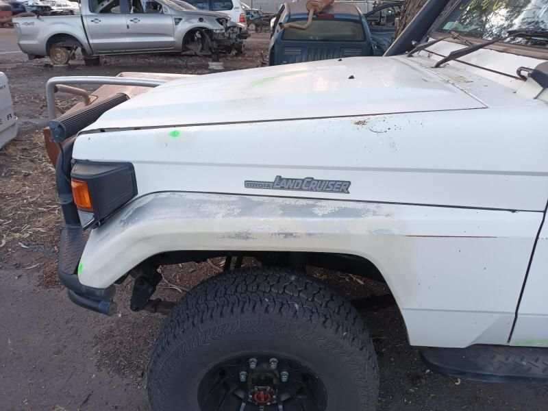 A White Truck With a Black Tire is Parked in a Parking Lot — South West 4WD Wreckers In Brisbane, QLD