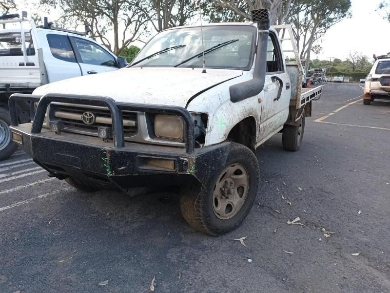 A White Truck is Parked on the Side of the Road in a Parking Lot — South West 4WD Wreckers In Brisbane, QLD