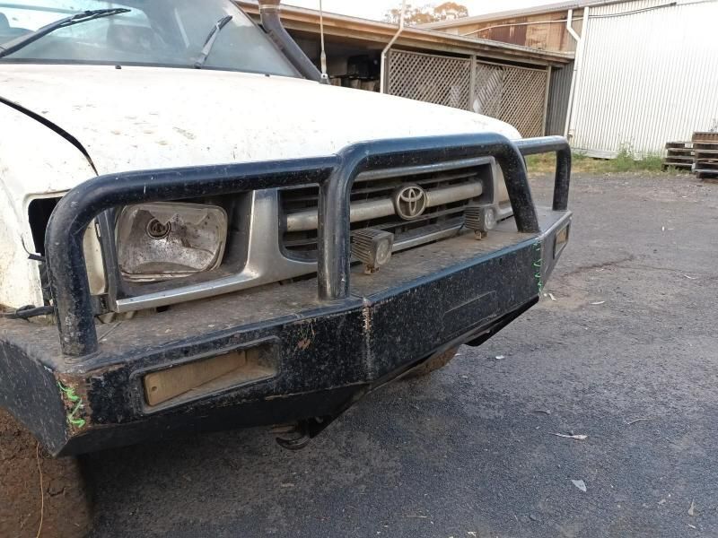 A White Truck With a Black Bumper is Parked in a Parking Lot — South West 4WD Wreckers In Brisbane, QLD