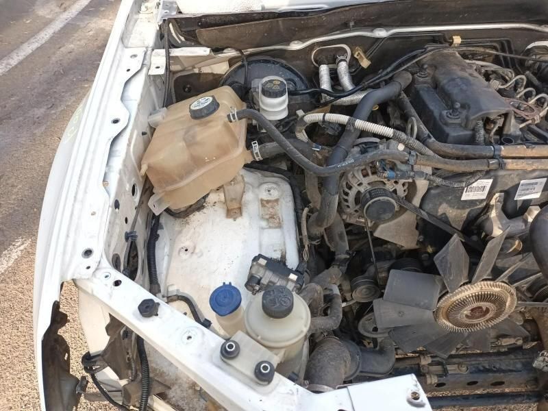 The Engine of a White Car With the Hood Open — South West 4WD Wreckers In Brisbane, QLD