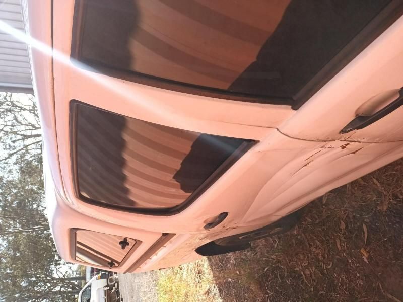 A White Car is Parked on a Dirt Road — South West 4WD Wreckers In Harristown, QLD