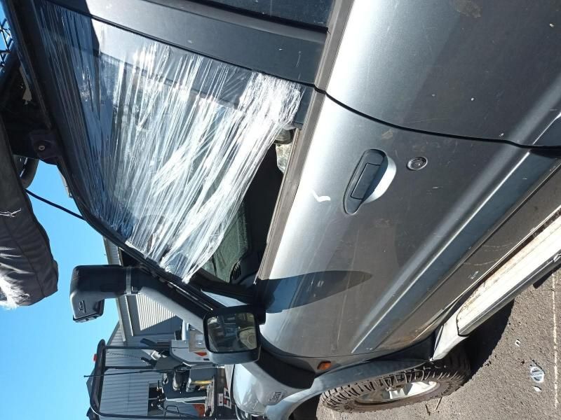A Silver Truck is Wrapped in Plastic and Has a Broken Windshield — South West 4WD Wreckers In Harristown, QLD