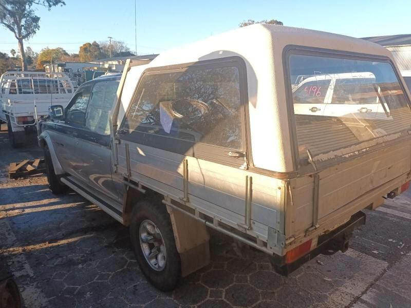 A Silver Truck With a White Canopy is Parked in a Parking Lot — South West 4WD Wreckers In Brisbane, QLD
