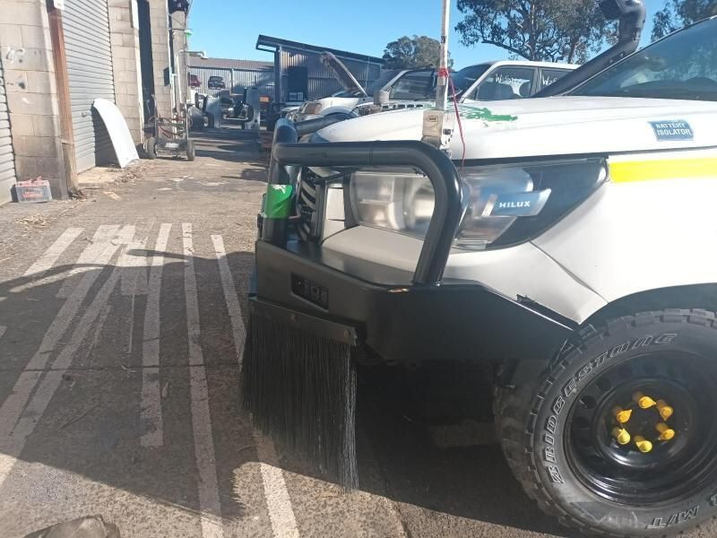 A White Golf Cart is Parked in a Parking Lot — South West 4WD Wreckers In Brisbane, QLD