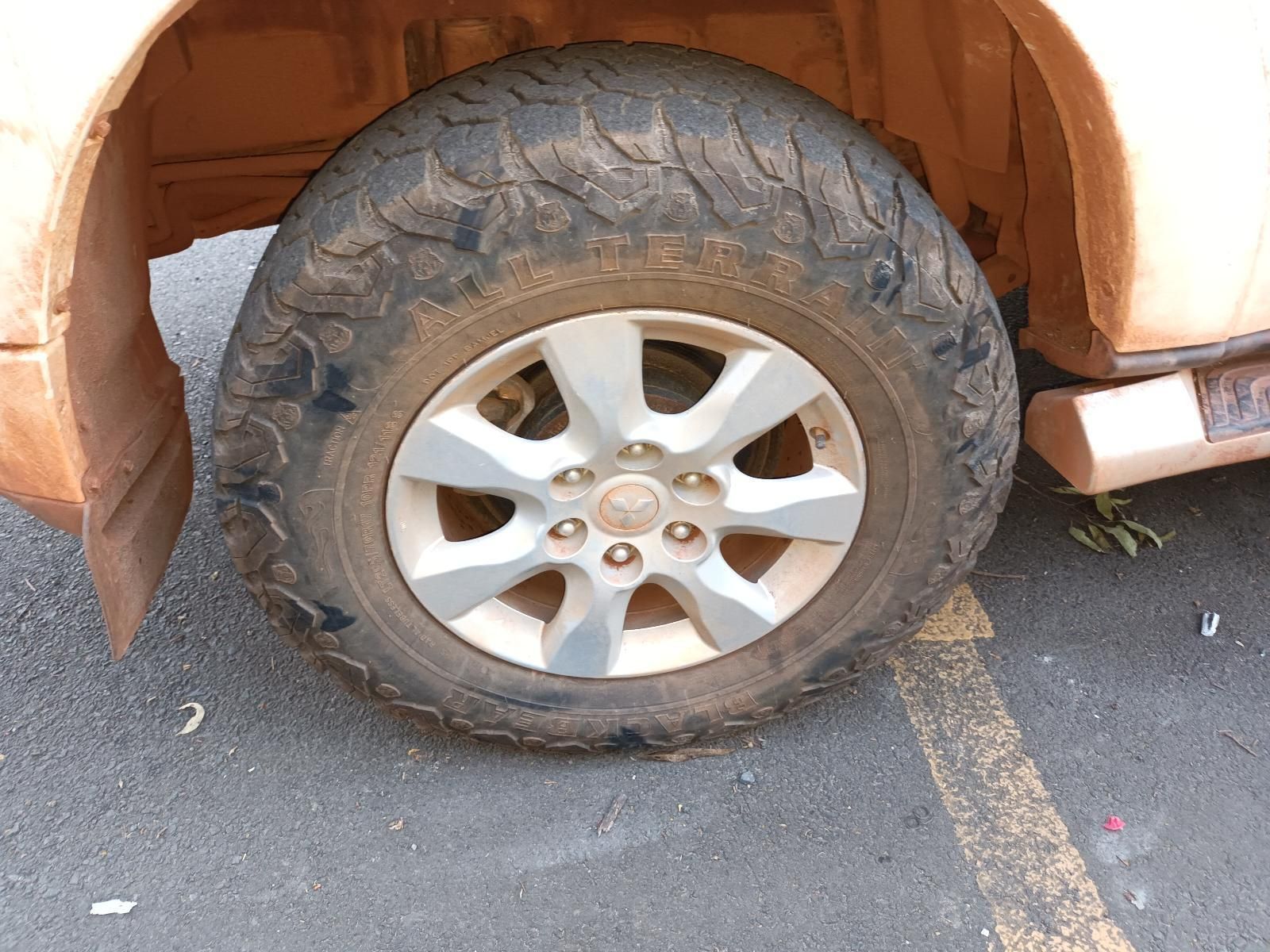 A Close Up of a Tire on a Car in a Parking Lot — South West 4WD Wreckers In Brisbane, QLD