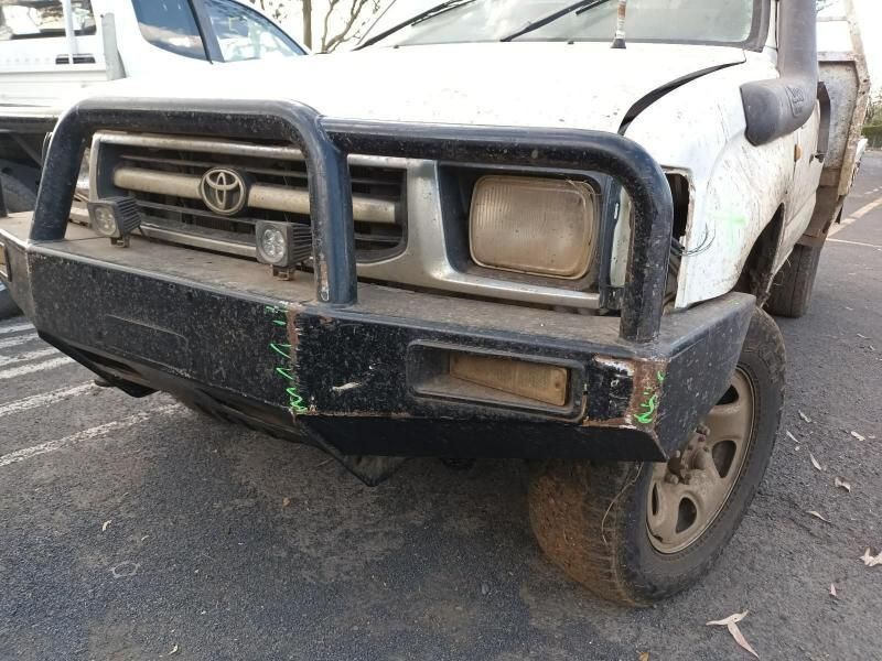 A White Truck With a Black Bumper is Parked in a Parking Lot — South West 4WD Wreckers In Brisbane, QLD