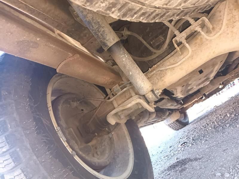 A Close Up of the Underside of a Car With a Tire Close Up of the Underside of a Car With a Tire