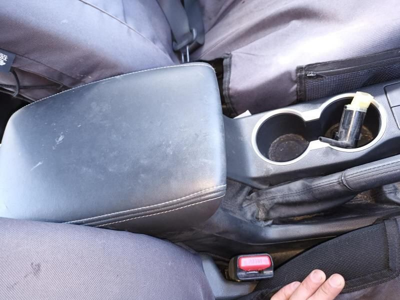 A Person is Holding a Cup Holder in a Car — South West 4WD Wreckers In Harristown, QLD