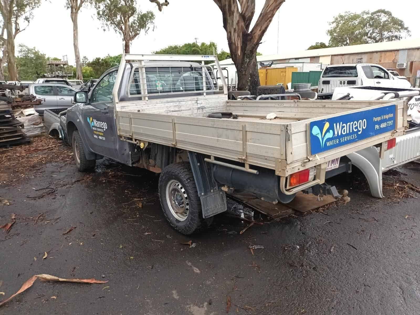 A Truck with a Wooden Bed is Parked on the Side of the Road — South West 4WD Wreckers in Harristown, QLD 