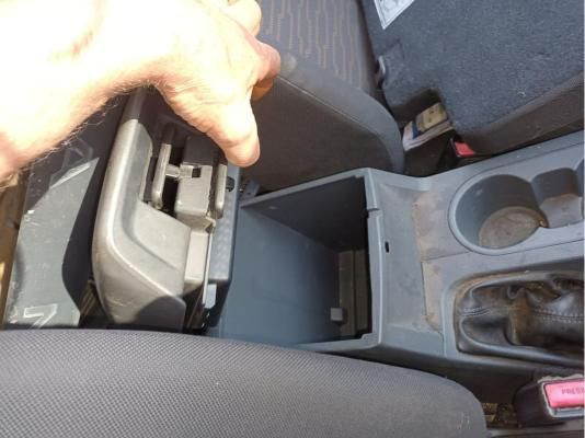 A Person is Reaching Into the Center Console of a Car — South West 4WD Wreckers In Brisbane, QLD