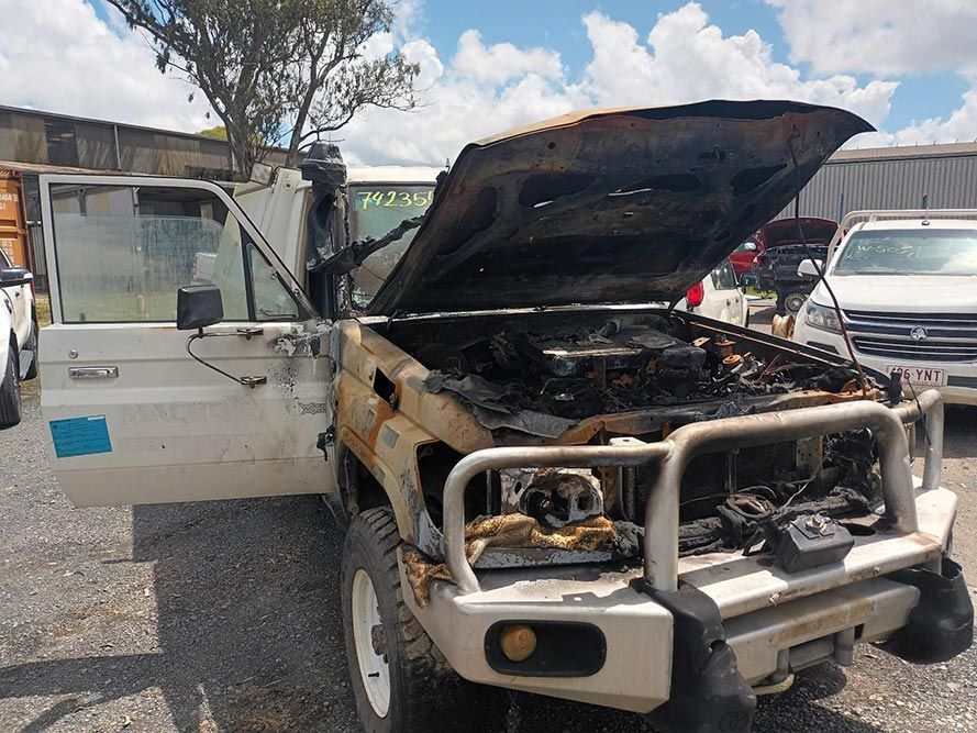 A White Truck with the Hood Up is Parked in a Parking Lot — South West 4WD Wreckers in Harristown, QLD 