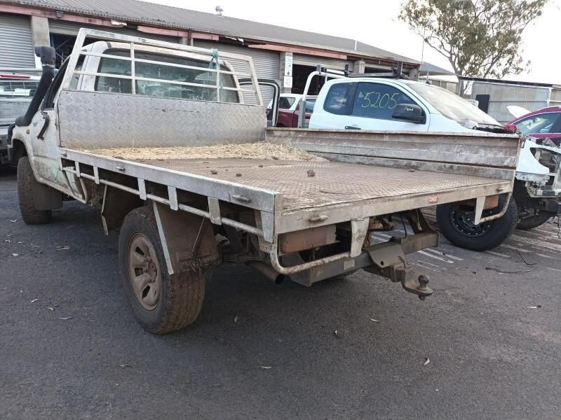A Truck With a Flat Bed is Parked on the Side of the Road — South West 4WD Wreckers In Brisbane, QLD