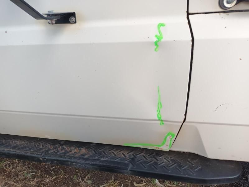 A White Car With Green Paint on the Side of It — South West 4WD Wreckers In Brisbane, QLD
