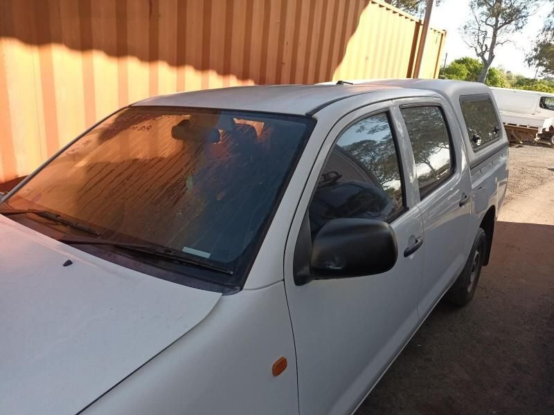 A White Truck is Parked in Front of an Orange Container — South West 4WD Wreckers In Harristown, QLD