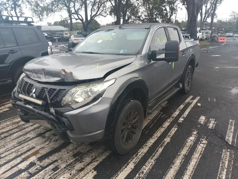 A Mitsubishi Triton Pickup Truck is Parked in a Parking Lot — South West 4WD Wreckers In Brisbane, QLD